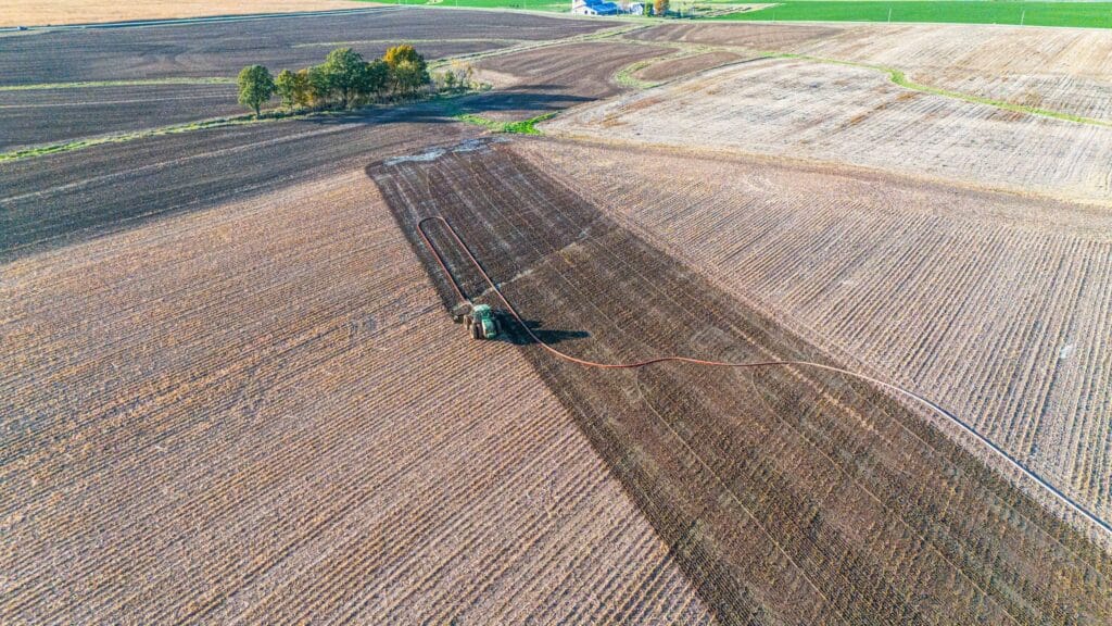High-powered dragline manure pump setup with hoses ready for field application to boost efficiency and save fuel