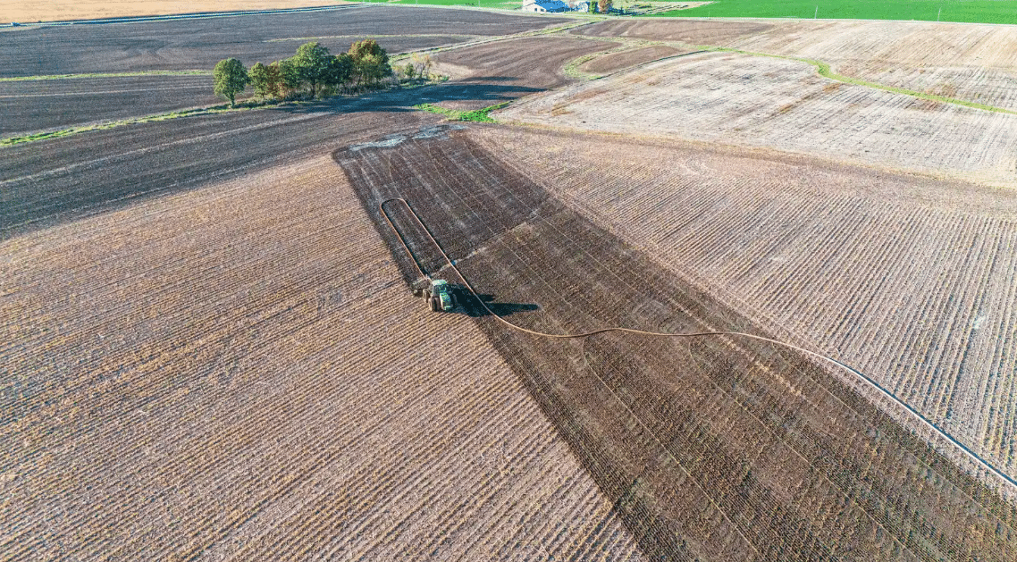 High-powered dragline manure pump setup with hoses ready for field application to boost efficiency and save fuel