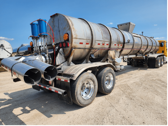 High-capacity stainless steel manure tanker used for liquid manure hauling and field application.