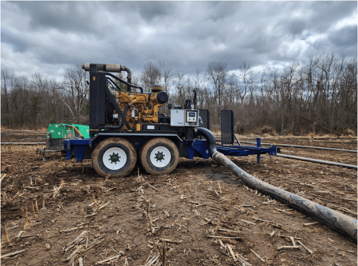 Heavy-duty manure pump operating in muddy field, efficiently handling liquid manure for modern farms.