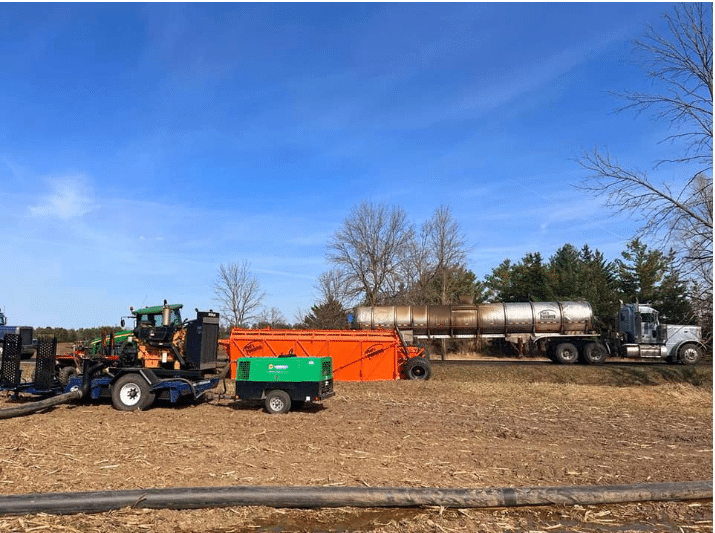 Portable diesel air compressor used for manure pumping cleanup, clearing hoses and toolbars efficiently.