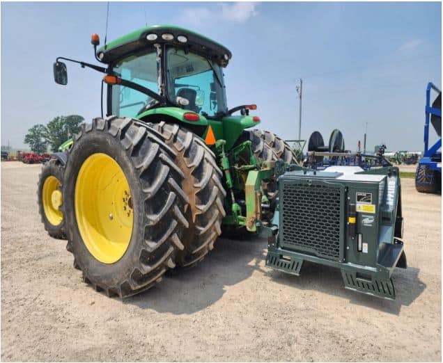Portable air compressor mounted on tractor used for hose clearing, tire inflation, and farm equipment maintenance
