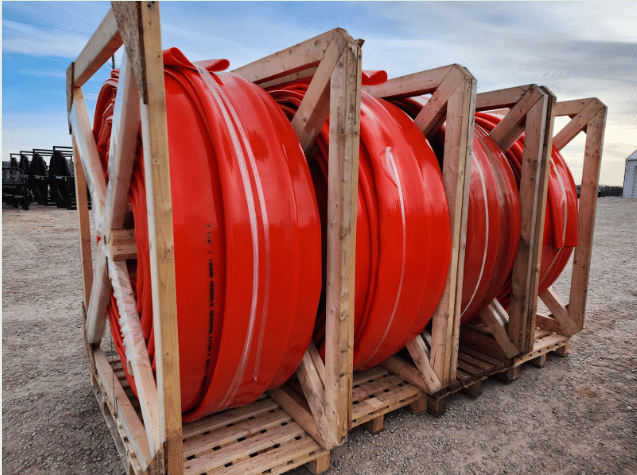 Stacked Mandals drag hose reels in wooden crates showing high-grade TPU construction and reinforced durability.