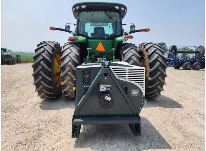 Air compressor tractor setup used for clearing manure hoses and supporting farm equipment operations in the field