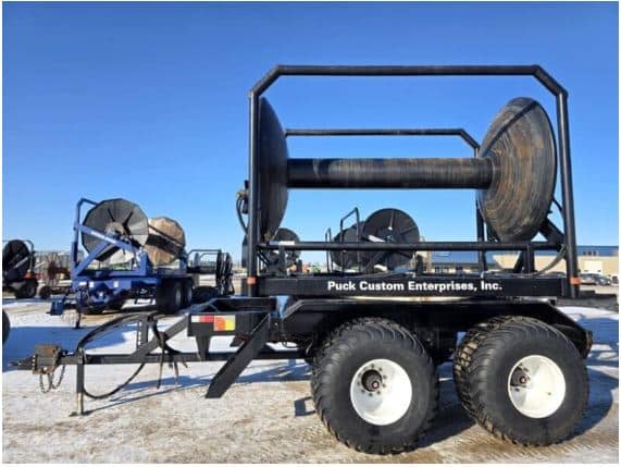 Puck Custom Enterprises used manure equipment, showcasing large spools for manure application.